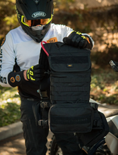 Load image into Gallery viewer, rider holding up the black vest