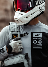 Load image into Gallery viewer, rider holding on to his Ghost Vest over one shoulder