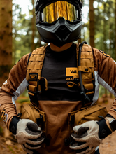 Load image into Gallery viewer, Rider buckling front straps of his Copper pack.